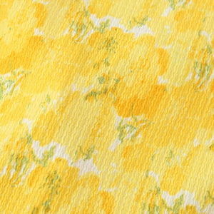 Yellow floral print blouse fabric with seersucker texture and ruffled feminine details