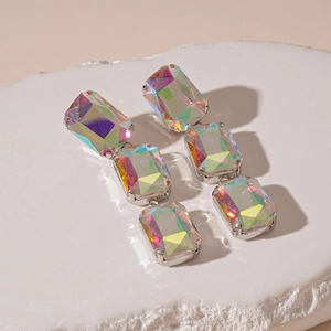 Detailed macro view of geometric square crystal earrings with vibrant AB iridescent coating