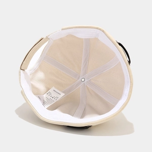Interior view of beige docker cap featuring reinforced seams and white sweatband details