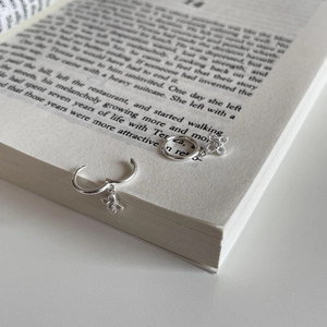 Minimalist S925 sterling silver hoop earrings with a floral zircon pendant on a book