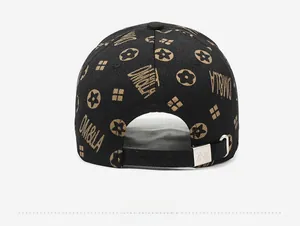 Detail view of the black baseball cap back with gold embroidery and metal buckle adjuster