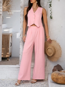 Detail of pink linen-texture V-neck vest and high-waist wide-leg pants on a model