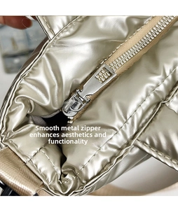 Detail of smooth silver hardware zipper head on metallic down tote bag