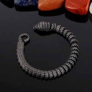 Macro view of textured snake scale pattern and vintage silver finish on biker bracelet