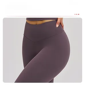 Detail of high-waisted V-cut waistband on dark purple yoga pants with matte finish texture
