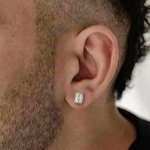 Close-up of emerald cut moissanite stud earrings in four-prong S925 silver setting