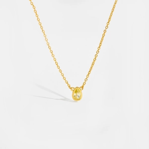 Detail of S925 sterling silver necklace featuring a drop-shaped yellow gemstone pendant