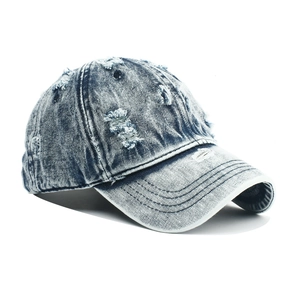 Vintage washed blue denim baseball cap with distressed ripped details and curved brim