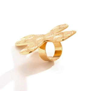 Macro view of gold metal heart ring with intricate spiral patterns and cross motifs