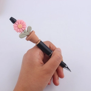 Creative black ballpoint pen featuring a pink daisy sunflower plant design on top