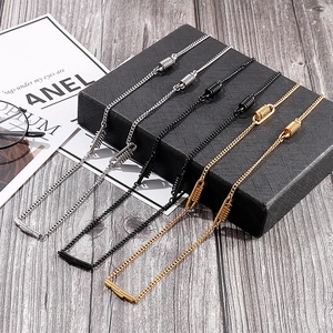 Detail of silver, black and gold metal eyeglass chains with spring coils and T-bar ends