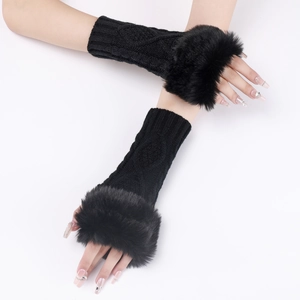 Detail of black cable knit fingerless gloves with luxurious faux fur trim for winter warmth