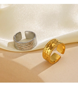 Close-up of gold and silver adjustable open rings with handcrafted hammered texture