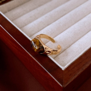 Close-up of gold plated adjustable tiger eye ring with vintage lava texture finish