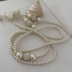 Elegant multi-layer pearl necklace featuring crystal-encrusted beads in a French vintage style