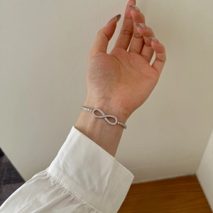 Detail view of S925 sterling silver Mobius bracelet with sparkling cubic zirconia on wrist