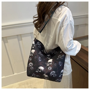 Detail of canvas crossbody bag with skull floral print and ethnic style wide strap
