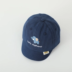 Detailed view of baby elephant embroidery and cotton texture on navy baseball cap