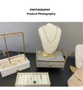 Detail of luxury white velvet jewelry display stands and drawer box with gold metal frame