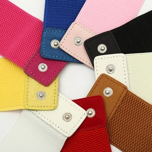 Close-up of elastic waist belts in various colors with metallic snap button closure