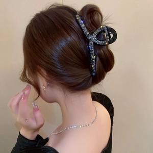 Detail showing high-quality rhinestone shark hair claw clip in an elegant updo