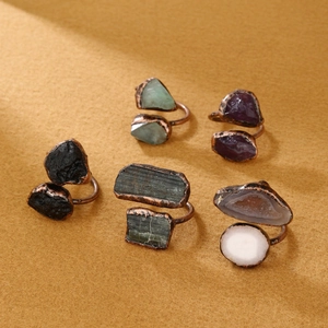 Vintage bronze open rings with various irregular natural raw stones on yellow background