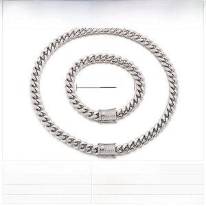 Detailed view of polished stainless steel Cuban chain set with rhinestone accents