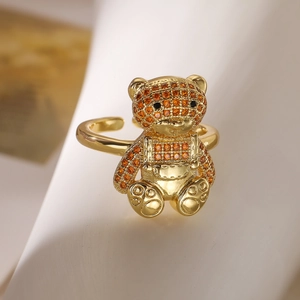 Macro shot of 18K gold plated bear ring with pavé orange zircons and adjustable band