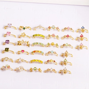 Detailed grid view of assorted gold rings with colorful zircon and floral patterns