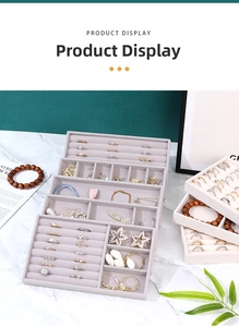 Detail view of beige velvet jewelry trays stacked on marble for organized accessory storage