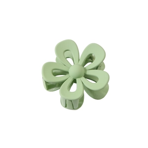 Detailed view of pale green flower hair claw clip with matte finish and metal spring