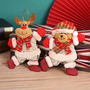 Plush Christmas reindeer and bear ornaments on vintage suitcase for holiday decoration
