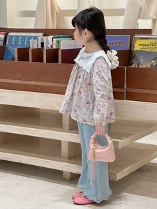 Detail of floral shirt with embroidered white collar and pink handbag for girls