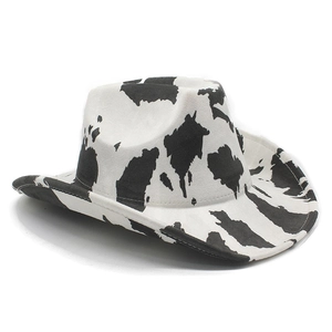 Macro side view of a western cowboy hat with black and white cow print suede texture