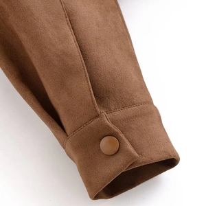 Detail of brown faux suede jacket cuff showing stitching quality and matching button
