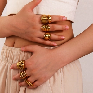 Chunky 18K gold plated stainless steel geometric rings set shown in a stylish layered look
