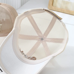 Detail view of the breathable mesh back and inner structural tape of the beige baseball cap