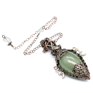 Close-up of vintage bronze star pendant necklace with green teardrop crystal gem