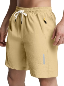 Detail of khaki quick-dry shorts with elastic waistband, white drawstring and reflective strip