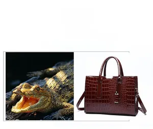 Detail view of deep wine red crocodile pattern leather texture with glossy silver buckle