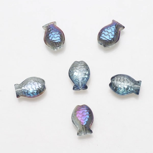 Detailed view of six iridescent blue-purple fish-shaped crystal glass beads for DIY jewelry