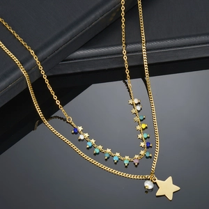 Detail of double-layer gold star necklace with colorful beads and pearl pendant