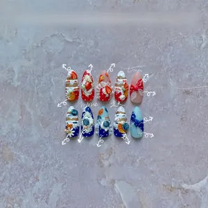 Detailed view of 3D embossed nail stickers with fruit and lace motifs on denim texture