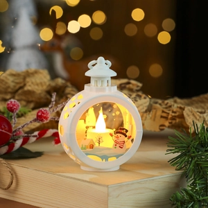 Close-up of white spherical Christmas lantern with LED candle and winter snowman scenery