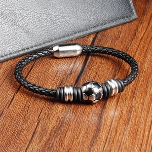 Detail of black woven leather bracelet featuring a silver football bead and magnetic clasp