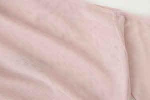 Detailed close-up of soft light pink mesh fabric showing fine texture and woven structure