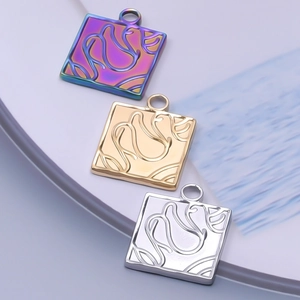Detail showing square stainless steel pendants in iridescent, gold, and silver finishes