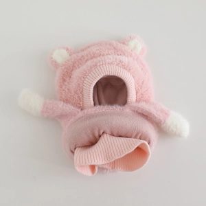 Detail of pink plush bear-ear hat with soft fleece texture and elastic ribbed cuff