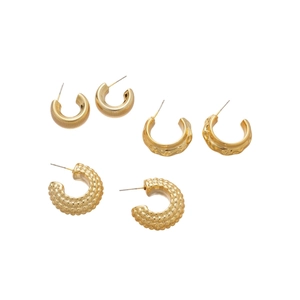 Minimalist C-shaped gold earring set with hammered, granular and threaded textures