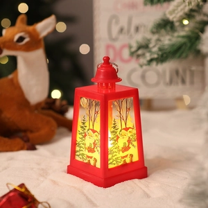 Detail of red Christmas lantern featuring Santa patterns and warm LED lights for holiday decor